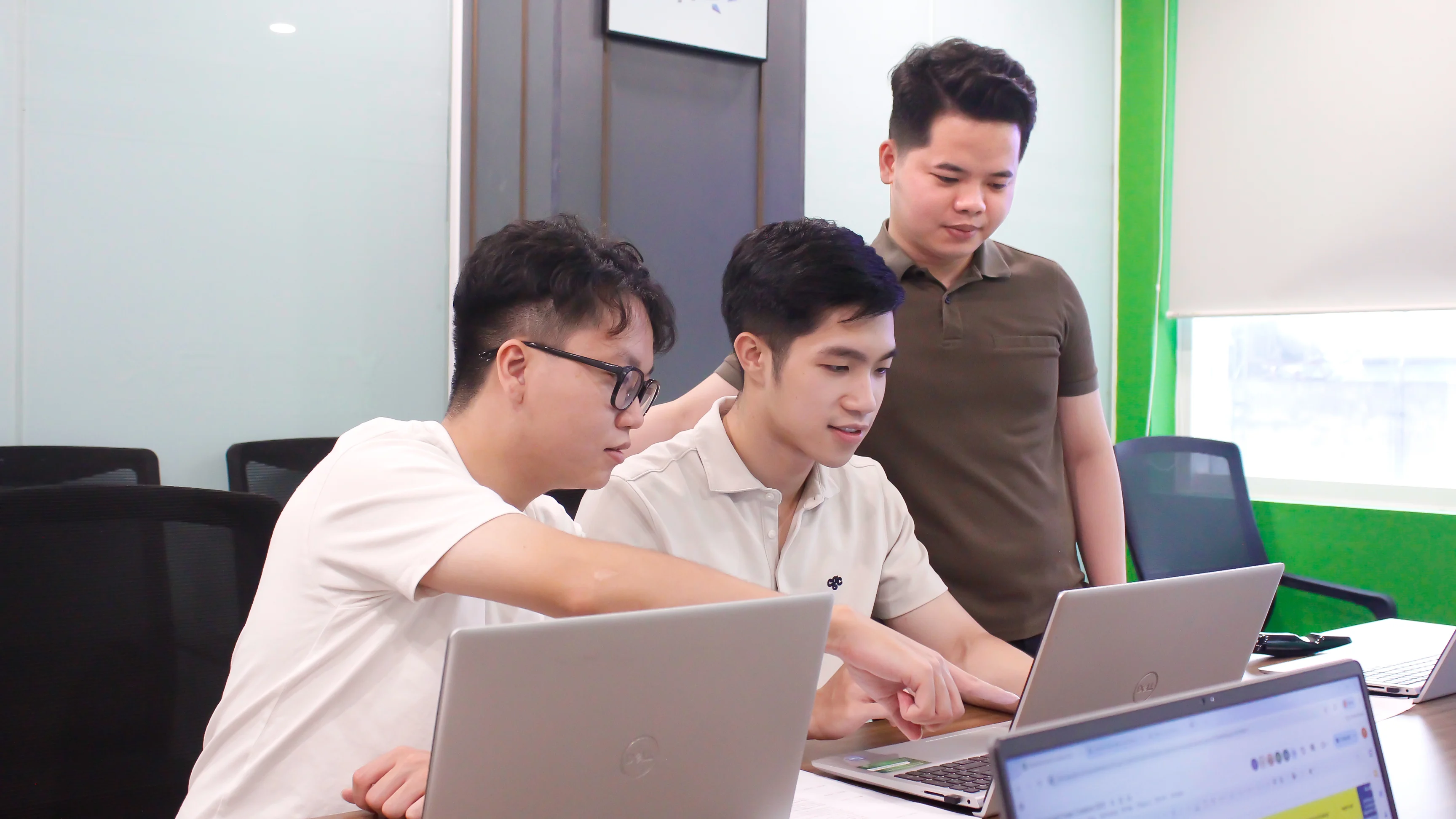 Team focused on laptop screen